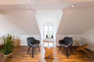two chairs and a table in a living room at Pension Sonne Appartements in Minden