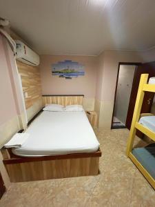 a bedroom with a bed in a small room at Apartamento Praia em Salvador Terreo in Salvador +6 photos