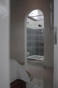 a bathroom with a shower with a glass door at Summer Homestay Bali in Nusa Dua