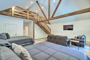 a living room with two beds and a couch at All-Encompassing Lakehouse with Modern Accents! in Fairfield Bay