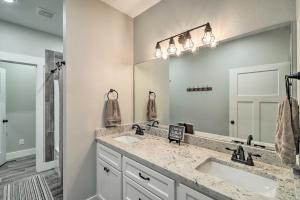 a bathroom with two sinks and a large mirror at All-Encompassing Lakehouse with Modern Accents! in Fairfield Bay +34 photos