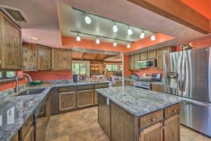 a large kitchen with wooden cabinets and granite counter tops at Sunny Sedona Retreat with Scenic Red Rock Views in Sedona