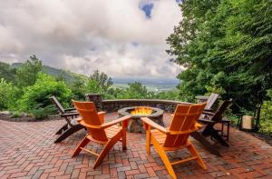 a patio with two chairs and a fire pit at Mountain View Sanctuary in Weaverville