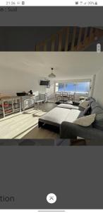 a living room with a large bed and a kitchen at appartement pendine 1 plein sud 53m2 in Puy-Saint-Vincent