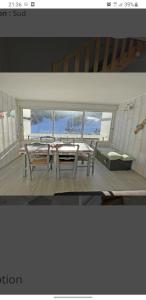 two pictures of a room with a table and a bench at appartement pendine 1 plein sud 53m2 in Puy-Saint-Vincent