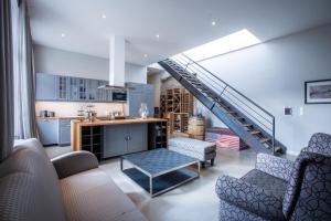 a living room with a kitchen and a staircase at 205m2 Penthouse with 75m2 Castle View Terrace and Barbercue - My Loft in Budapest in Budapest