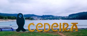 a sign in front of a body of water at Precioso estudio en Cedeira. in Cedeira +2 photos