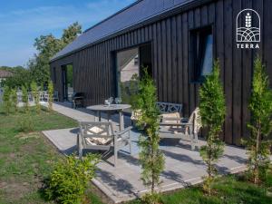 a building with a table and benches in front of it at Terra House in Ventspils