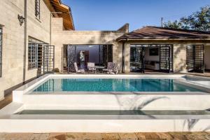 a swimming pool in the backyard of a house at The Landing Nanyuki - One Bedroom Guest house in Nanyuki