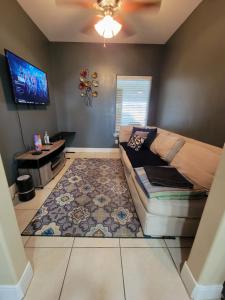 a living room with a couch and a rug at Modern, Private, Smart 4 BR Condo in Desirable Location in McAllen with Pool! in McAllen