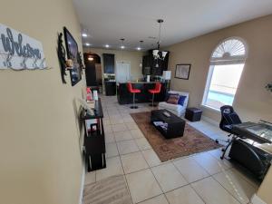 a room with a living room and a kitchen at Modern, Private, Smart 4 BR Condo in Desirable Location in McAllen with Pool! in McAllen