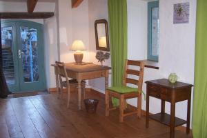 a room with a desk and a chair and a table at Salomony Chambre d'Hôtes in Marcols-les-Eaux