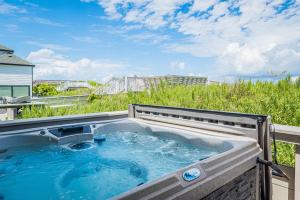 a hot tub on the side of a building at Dunes for Days in Nags Head