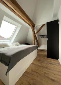 een slaapkamer met een groot bed en een raam bij DESIGN-Studio CHURCH 46 in Mülheim an der Ruhr