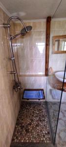 a shower with a glass door in a bathroom at Casa Qeparo in Qeparo