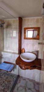 a bathroom with a white sink and a shower at Casa Qeparo in Qeparo