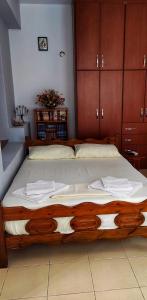 a large bed in a room with wooden cabinets at Casa Qeparo in Qeparo