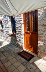 an entrance to a stone building with a wooden door at Casa Qeparo in Qeparo