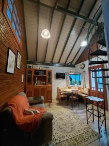 a living room with a couch and a table at Recanto Pôr do Sol in Nova Petrópolis