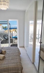a bedroom with a bed and a view of the ocean at Villa Casa Amada in Callao Salvaje
