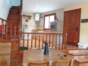 a kitchen with a table with a vase on top of it at Casa de los sueños in Cadiñanos
