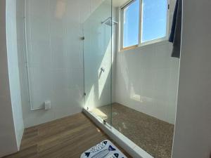a shower with a glass door in a bathroom at TORRE MAR Frente al Malecón in Mazatlán +10 photos