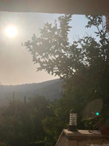 a view of a valley with the sun in the sky at ORJAN VIEW in Irjān