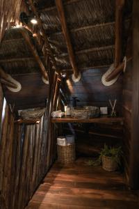 an inside view of a room in a wooden cabin at Casa Hayhu in Mahahual