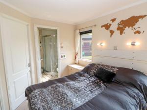 a bedroom with a bed and a map on the wall at 6 Badgers Retreat in Richmond