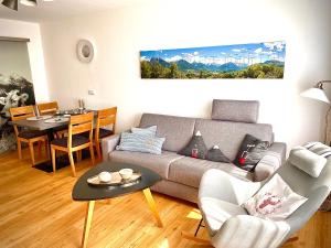 un salon avec un canapé et une table dans l'établissement Allgäu-Ferienwohnung Jung, à Fischen im Allgäu