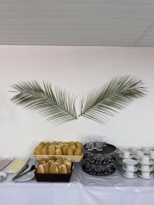 a table with food and a palm branch on the wall at Caminito Beach Hotel in Aquiraz