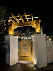 a wooden gate with lights on it at night at Colony Club Inn & Suites in Nassau