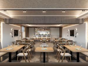 a restaurant with wooden tables and chairs and a bar at Bontiak Hotel in Kyiv