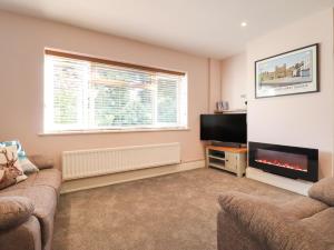 a living room with a couch and a flat screen tv at Albies End in Battle