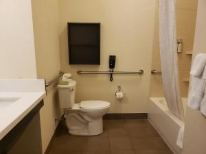 a bathroom with a toilet and a sink and a tub at Candlewood Suites MORGANTOWN-UNIV WEST VIRGINIA by IHG in Morgantown