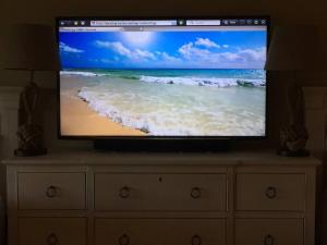 a flat screen tv sitting on top of a dresser at Gated Sawgrass Beach Club Villa in Sawgrass Country Club in Ponte Vedra Beach