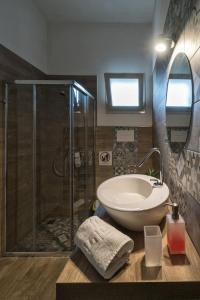 a bathroom with a sink and a shower with a sink at Casa vacanze "Ulivi nel Mare" in Sciacca