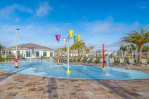 a pool with a water park with fountain at Villa, private pool, water park, Orlando parks in Kissimmee