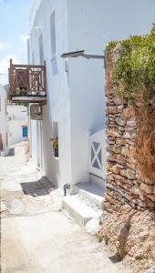 a small alley with a stone wall and a building at Ornella's & Laura's secret place in Livadia