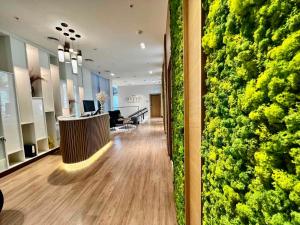 a lobby with a green wall in a building at My Sunshine Apartments in Batumi in Batumi +164 photos