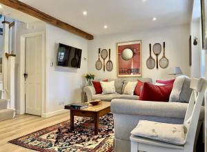 a living room with a couch and a table at The Old Stables in Lodsworth