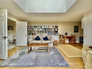 a living room with a couch and a table at Library Cottage in Thakeham