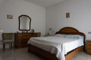 a bedroom with a bed and a dresser and a mirror at A'rasal in Irsina