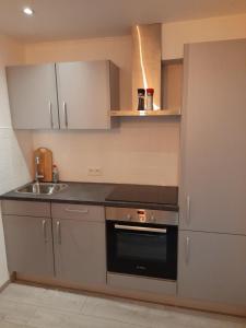 a small kitchen with a stove and a sink at Gîte En Li Esse in Huy