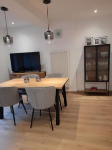 a dining room with a wooden table and chairs at Gîte En Li Esse in Huy