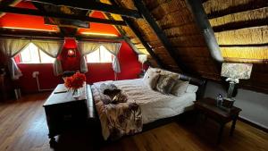 a bedroom with a large bed in a attic at Farm Vibes Guest House in Brits