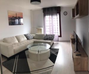a living room with a couch and a coffee table at Apartment Vrbani in Zagreb