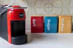 a toaster sitting next to four different colored containers at Casa Raffaela in Modica