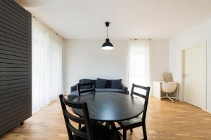 a dining room with a black table and chairs at Sara in Bucharest