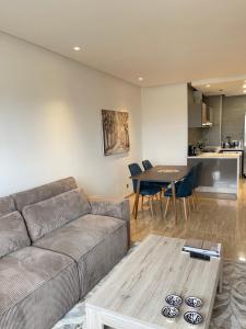 a living room with a couch and a table at Luxury Flat in Casa Finance City in Casablanca